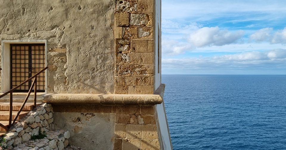 Particolare del prospetto della torre di San Giovanni. Sullo sfondo il mare e il cielo azzurro.