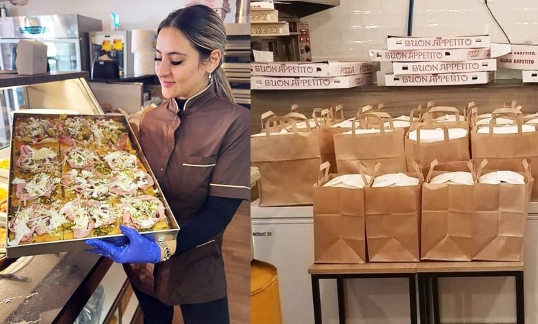 Al Panificio del Monte di Augusta una ragazza mostra una teglia di pizza; accanto, i sacchetti di cibo pronti da donare